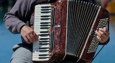 Man playing an old fashioned accordion instrument