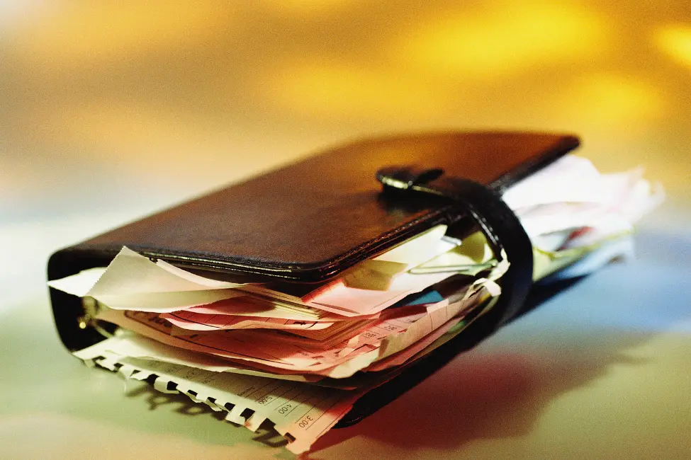 filofax personal organiser bursting with extra paper