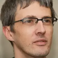 Brian Teeman wearing glasses and clean shaven