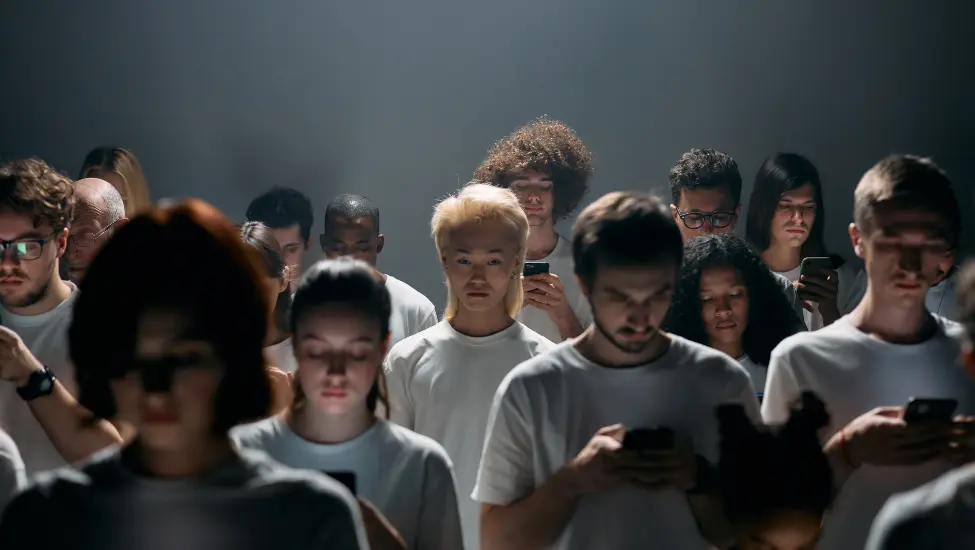 crowd of people all looking at their phones