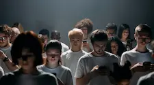 crowd of people all looking at their phones