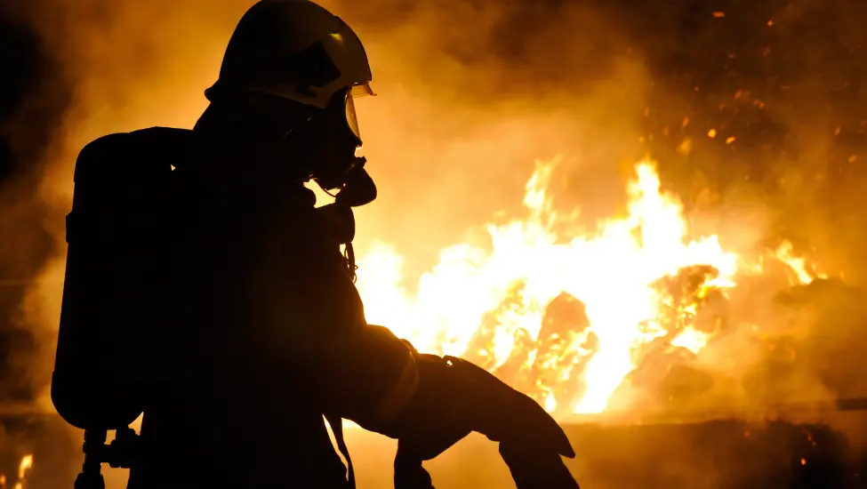 Firefighter in front of a large fire