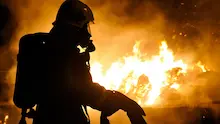 Firefighter in front of a large fire