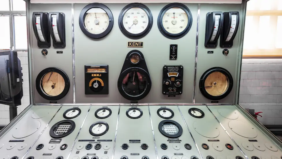 control panel with lots of dials and guages probably from a power station