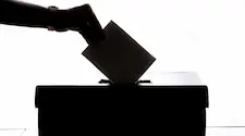 silhouette of someone casting their vote in an election